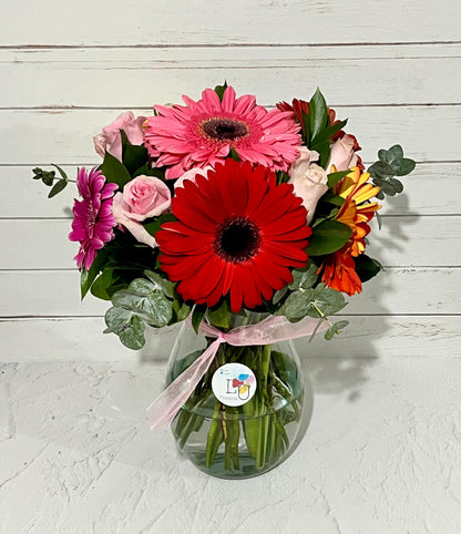 Arreglo gerberas multicolor con rosas rosadas